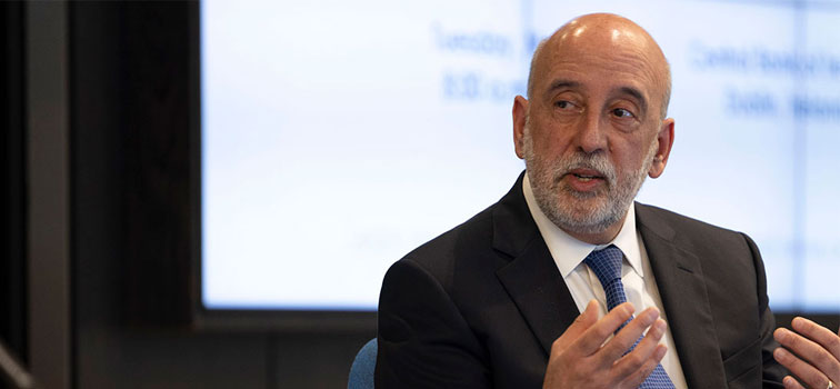 Governor Makhlouf Governor Makhlouf holding his hands up with a lit-up screen in the background