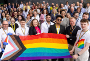 Crowd holding the Pride flag