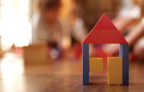 Toy bricks with a red triangle, and two blue legs and three squares with background shaded out