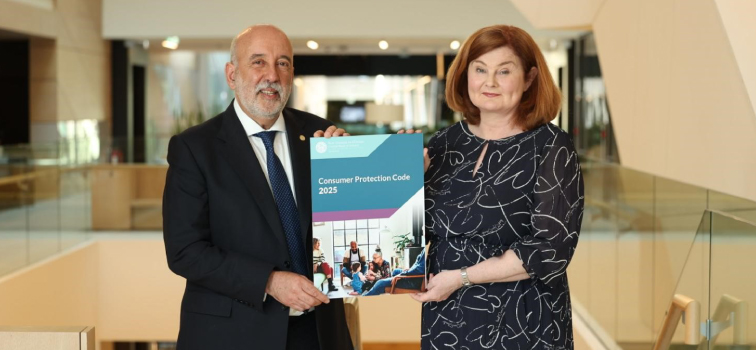 Governor Gabriel Makhlouf and Deputy Governor Derville Rowland holding up a copy of the Consumer Protection Code 2025