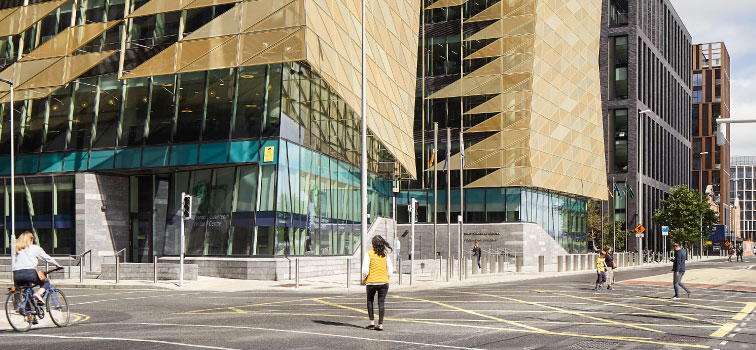 People walking and cycling at the Central Bank of Ireland building